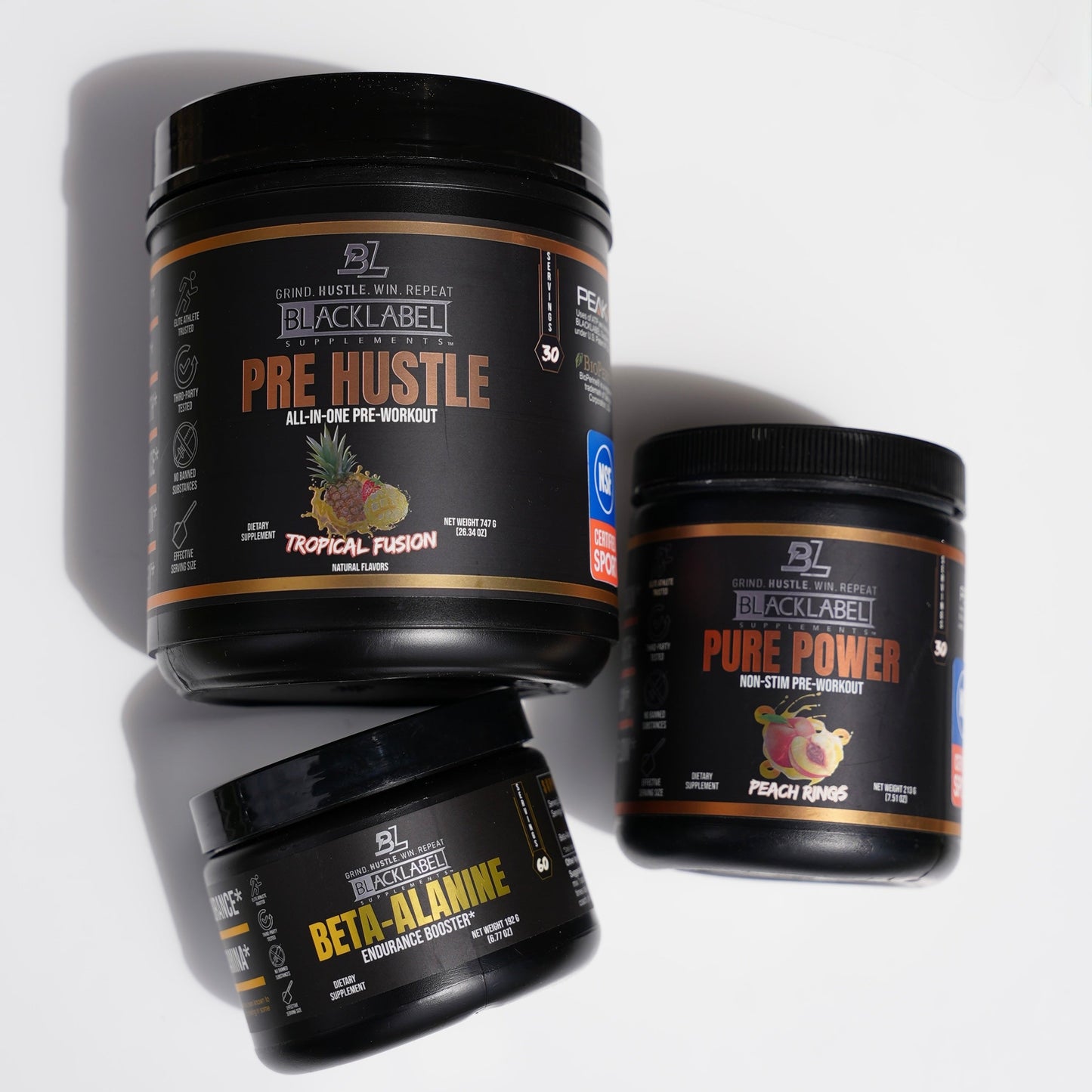 BlackLabel performance supplement stack featuring Pre Hustle Tropical Fusion pre-workout, Beta-Alanine endurance booster, and Pure Power non-stim pre-workout displayed on a clean white background for strength, endurance, and workout support.