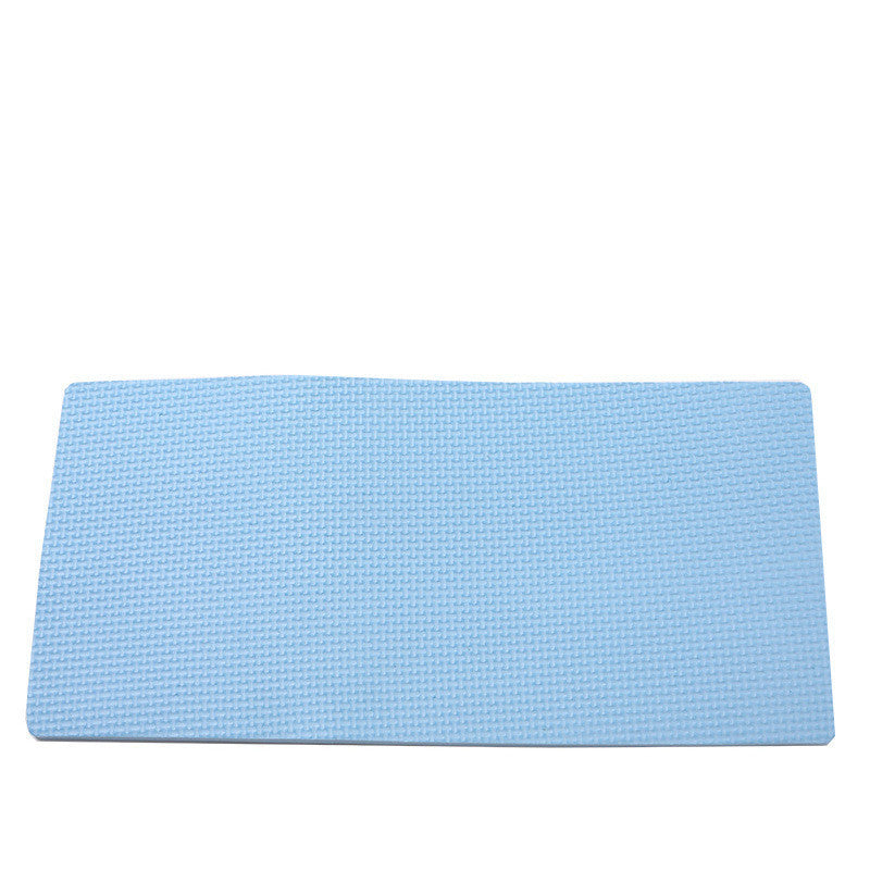 Light blue textured exercise mat designed for use with an ab roller, shown on a white background to help protect floors and improve workout comfort.