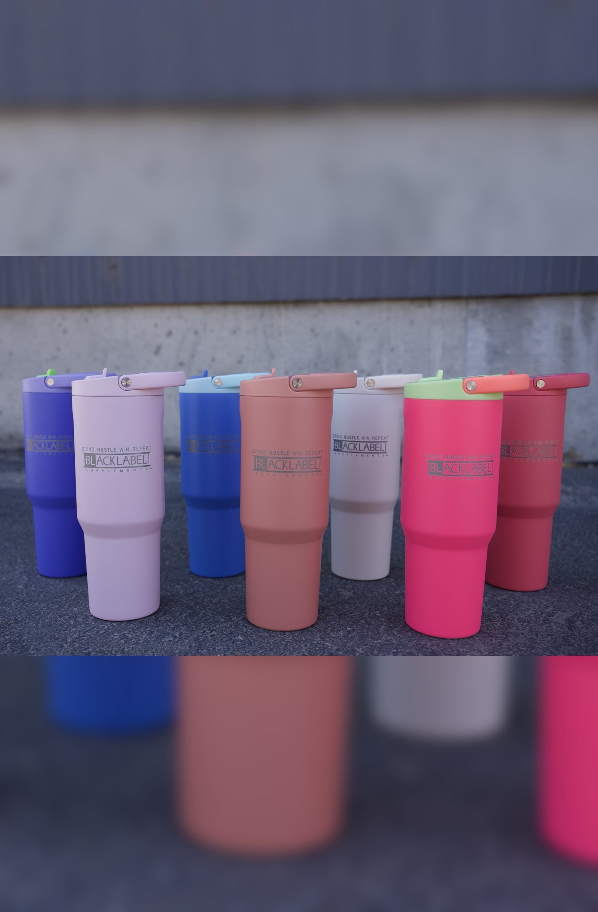 Collection of BLACKLABEL 32 oz insulated sport cups in multiple colors with flip straw lids, showcasing matte finishes and travel-friendly designs for hydration at the gym, office, or on the go.