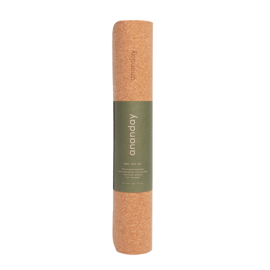 Rolled Ananday cork yoga mat with a natural cork exterior and olive green branded wrap, showcasing its portable, eco-friendly design for yoga, Pilates, stretching, and fitness workouts.