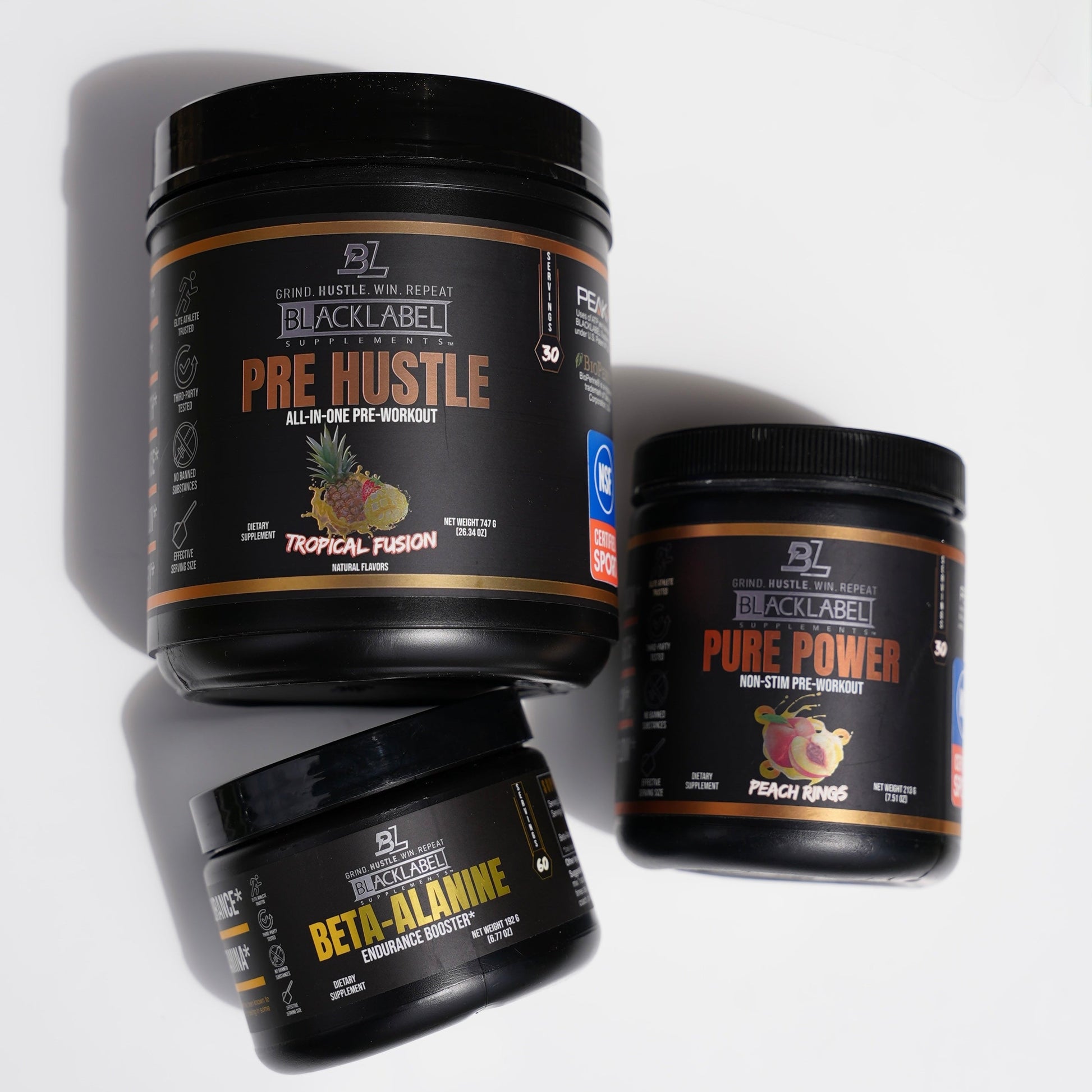 BlackLabel performance supplement stack featuring Pre Hustle Tropical Fusion pre-workout, Beta-Alanine endurance booster, and Pure Power non-stim pre-workout displayed on a clean white background for strength, endurance, and workout support.