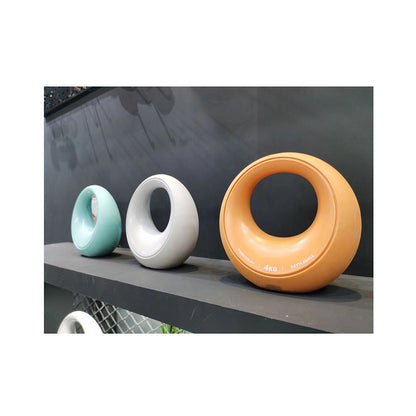 Three adjustable dumbbells in azure, dark gray, and burning orange displayed on a shelf, showcasing available color options for home strength training.