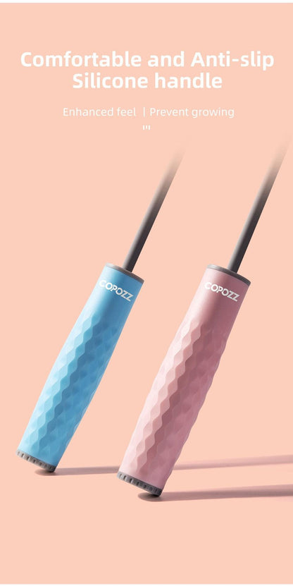 lose-up of blue and pink textured silicone handles on an adjustable speed jump rope, designed to provide a comfortable, secure grip during cardio and fitness workouts.