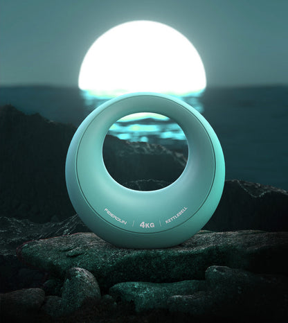 Azure 4 kg adjustable dumbbell with ergonomic circular grip displayed on rocks with a scenic waterfront background, highlighting its modern design for home strength training.