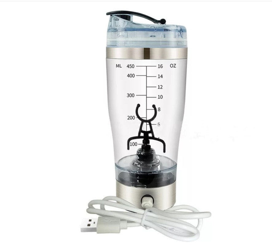 A USB-powered tumbler blender with a clear plastic cup showing liquid level markings in milliliters and ounces, a brushed silver metal base, a black lid, and a coiled white USB charging cable on a white background.