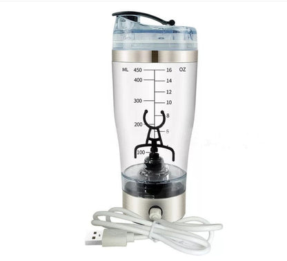 A USB-powered tumbler blender with a clear plastic cup showing liquid level markings in milliliters and ounces, a brushed silver metal base, a black lid, and a coiled white USB charging cable on a white background.