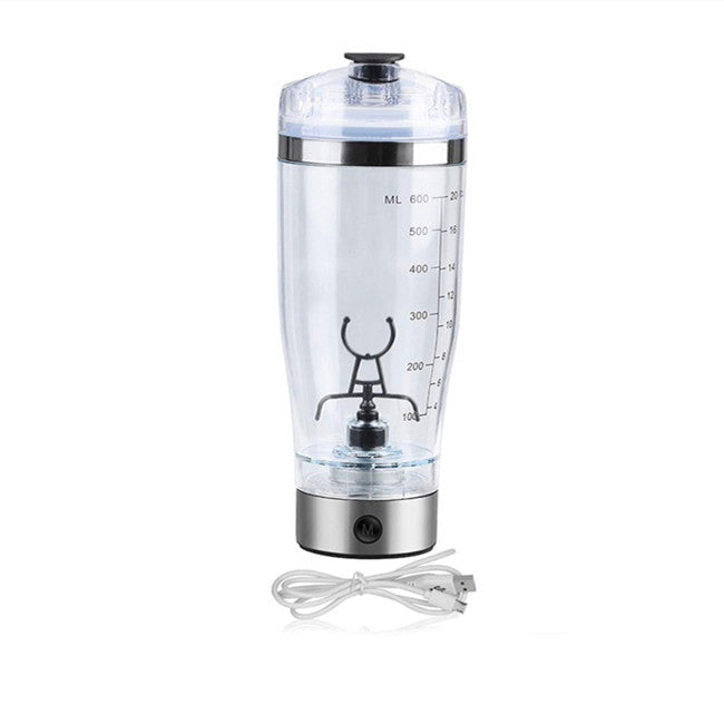 Clear blender bottle with measurement markings and a power cord on a white background