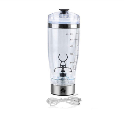 Clear blender bottle with measurement markings and a power cord on a white background