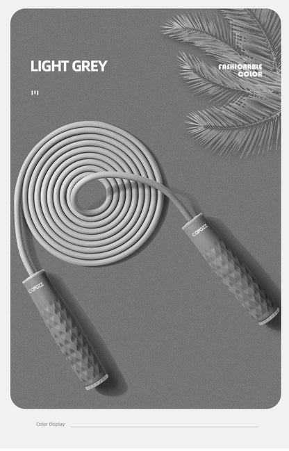 Light gray adjustable speed jump rope with textured anti-slip silicone handles and durable PVC cable for cardio, boxing, and home fitness workouts.