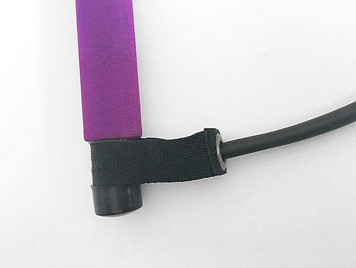 Close-up of the foam grip handle on a portable Pilates bar resistance band training kit, featuring a secure attachment point for comfortable home workout exercises.