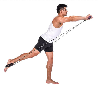 Man performing a single-leg balance exercise with a portable Pilates bar resistance band training kit to strengthen the core, legs, shoulders, and upper body during a home workout.