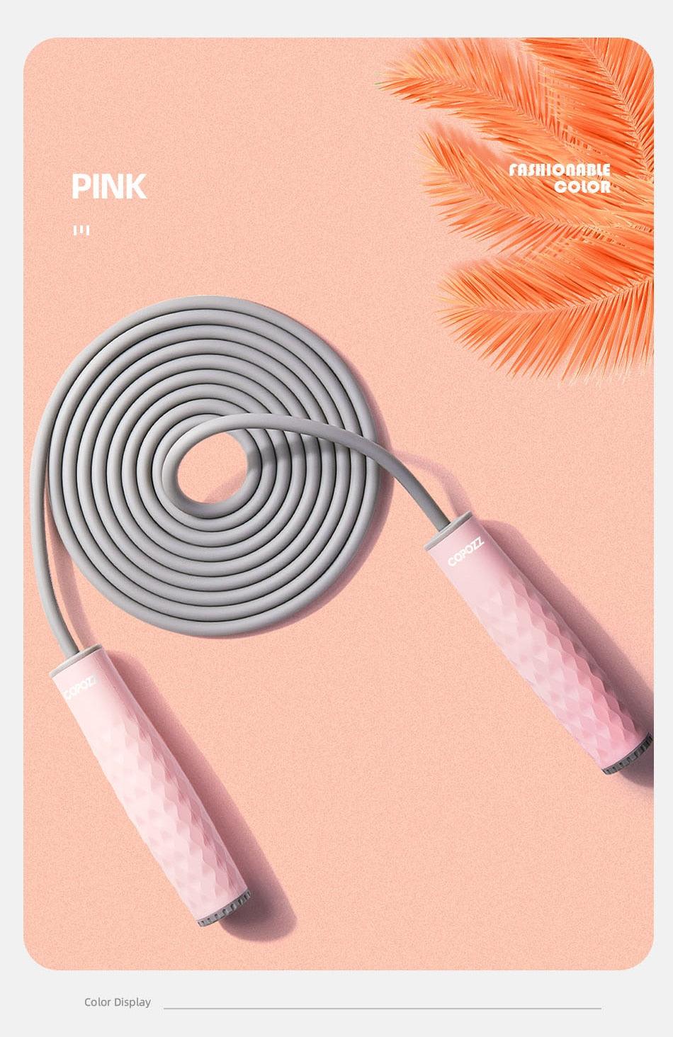 Pink adjustable speed jump rope with textured anti-slip silicone handles and durable PVC cable for cardio, boxing, and home fitness workouts.