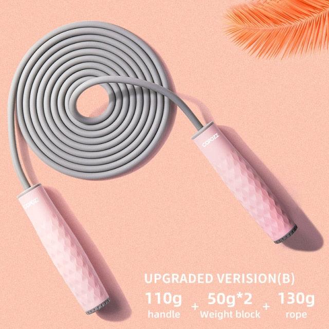 Pink upgraded weighted speed jump rope with textured ergonomic handles and a durable PVC-coated cable for cardio, boxing, HIIT, and home fitness workouts.