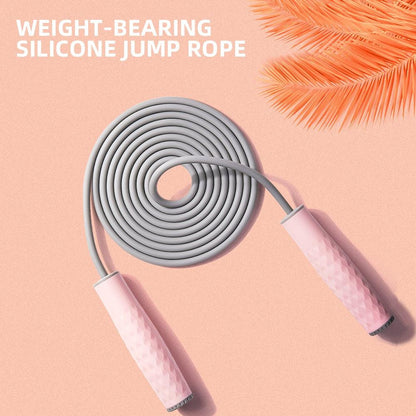 Pink weighted silicone speed jump rope with textured ergonomic handles and durable PVC-coated cable for cardio, boxing, HIIT, and home fitness workouts.