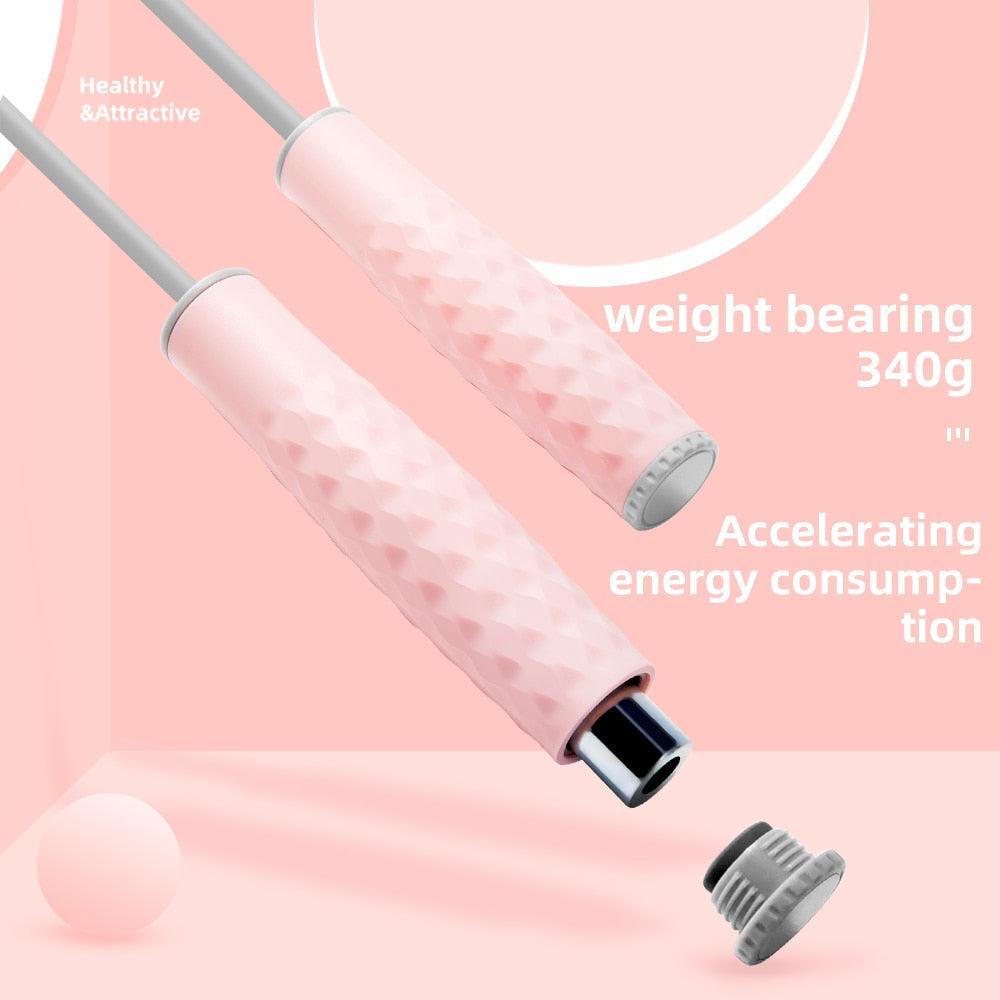 Close-up of pink weighted speed jump rope handles with removable weight block, textured non-slip silicone grip, and ergonomic design for cardio, boxing, HIIT, and home fitness workouts.